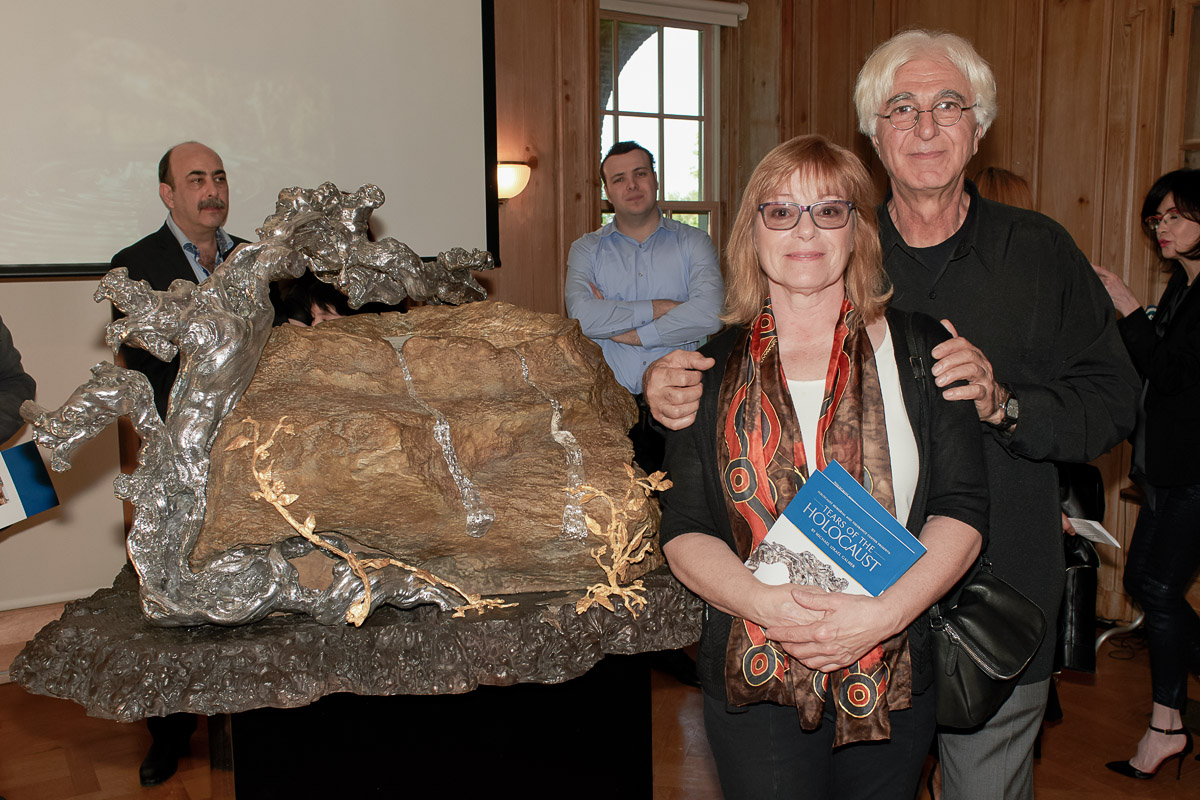 Photo of silver sculpture artist Michael Galmer at the 'Tears of the Holocaust' opening reception at Holocaust Museum.